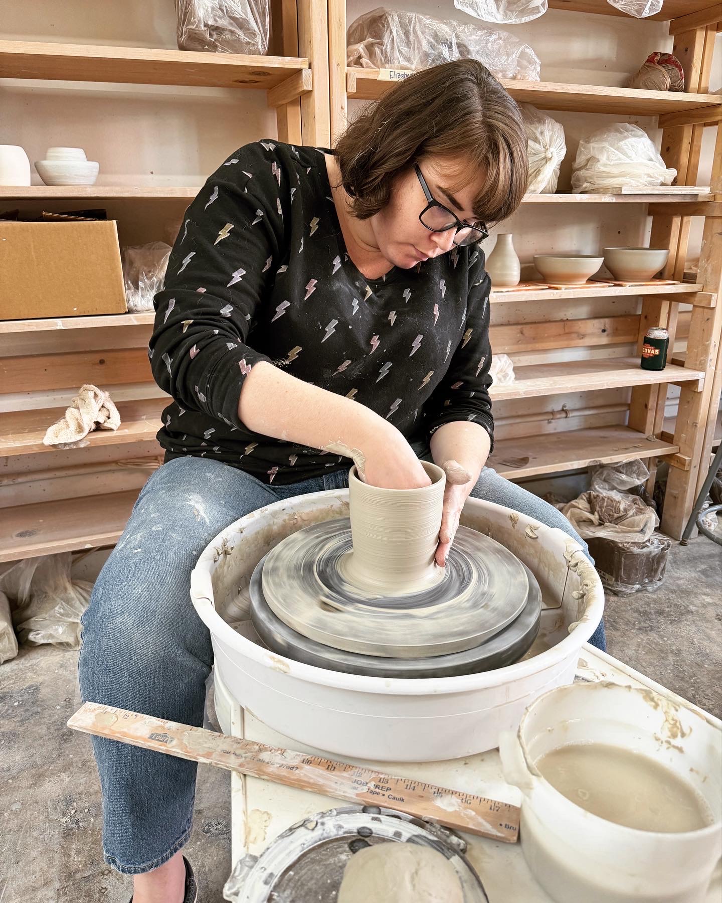 Katherine making a mug on a pottery wheel